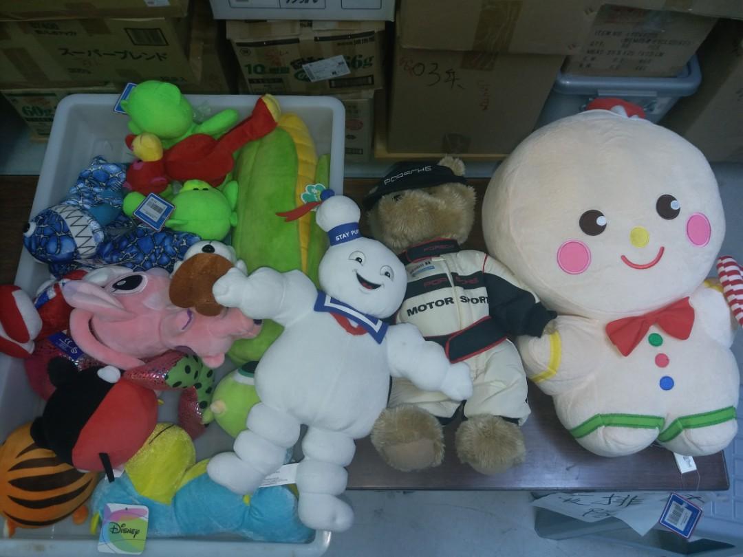 A bunch of stuffed animals, big and small, and some with tags
